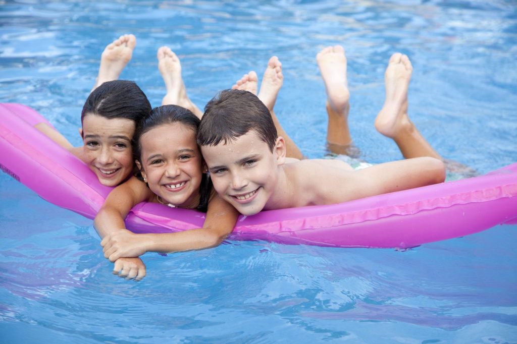 Children at the swimming pool of camping Saint Michel Chef